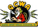 The QCWA logo: a white bearded man working a key.