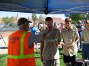 While Frank Eldridge, W7GGR, holds the microphone, a Boy Scout at the 2010 Centennial Camporall at St George, Utah, puts his question to ISS astronaut Doug Wheelock, KF5BOC. [Gary Zabriskie, N7ARE Photo]