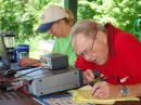 Bob Osterloh, K0RAO,  at the microphone and Carolyn Kramkowski, K2NYY, logging for the St Charles Amateur Radio Club on Field Day.  [Ron Ochu, KO0Z, Photo]