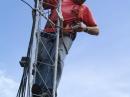 After installing the new tower, Matt Strelow, KC1XX, of XX Towers, gets ready to install the modifications to the W1HQ SteppIR antenna. [S. Khrystyne Keane, K1SFA, Photo]