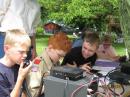 Under the watchful eyes of control ops KC7FYD and KC7CFR, six scouts from Troop 259, Dallas, Oregon, enjoyed meeting other scouts and other young people on the ham bands during last Junes Kids Day. 